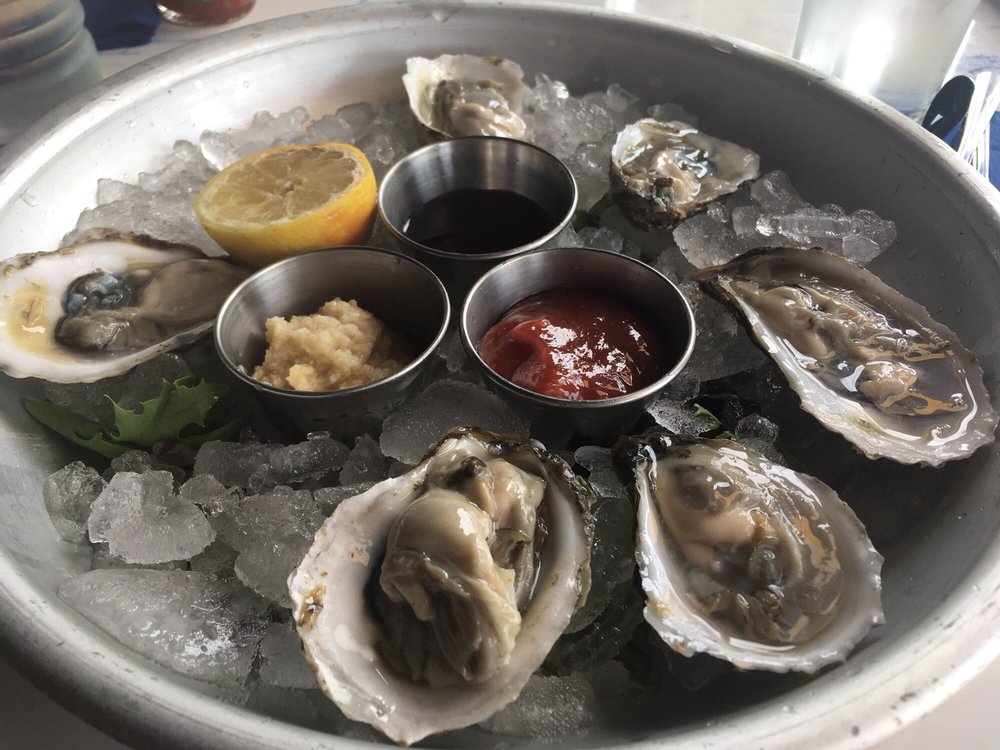 Half-dozen fresh oysters on the half shell with lemon, cocktail sauce, and mignonette
