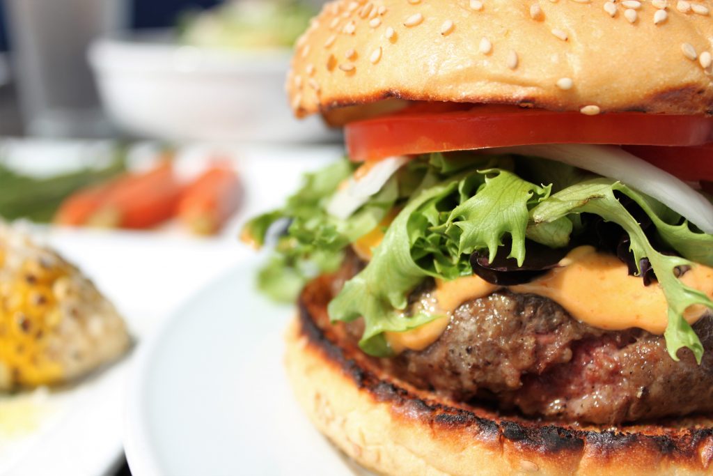 Beach Burger on a sesame bun with tomato, lettuce, onion, and chipotle mayo
