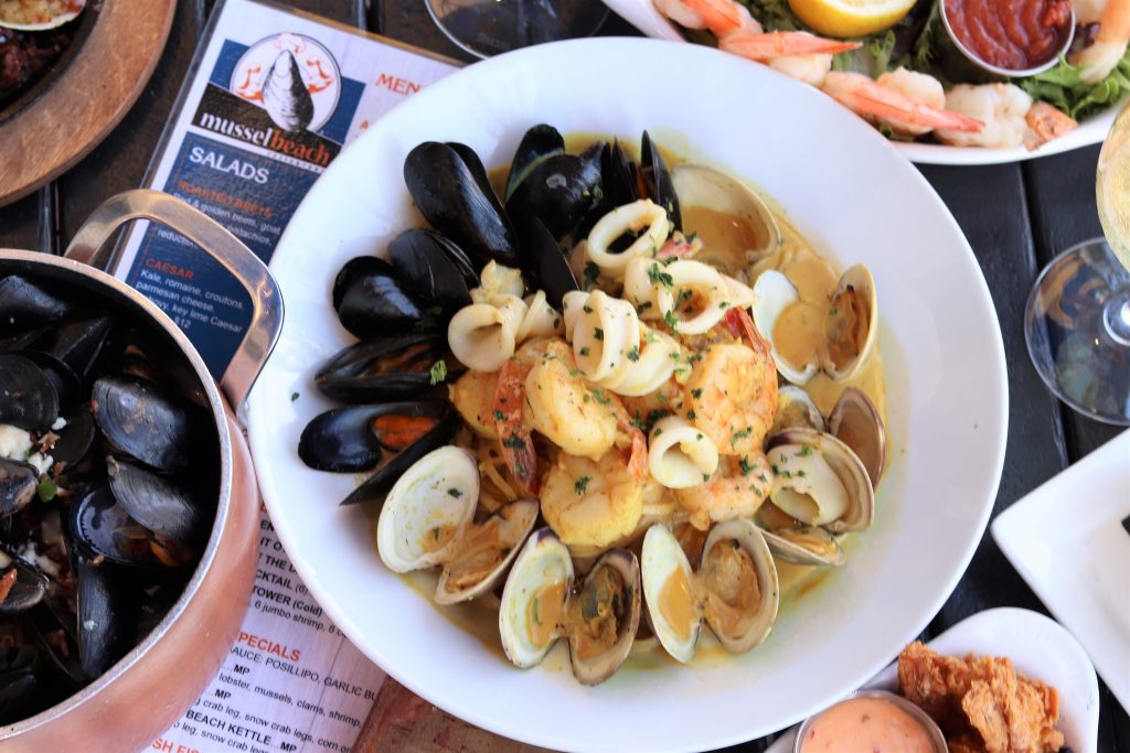Seafood Paella - Mussels, clams, squid, scallop, shrimp, sausage, yellow rice, saffron sauce.