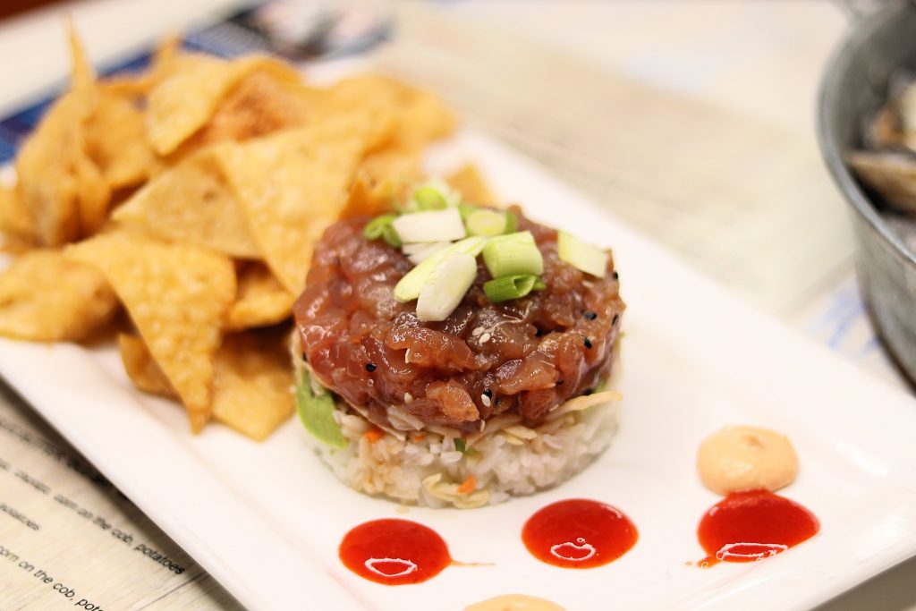 Tuna Stack - Sushi grade tuna, slaw, ginger soy, avocado, coconut ginger rice, wonton chips, chipotle aioli, sriracha